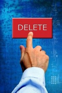 male_hand_pushing_a_red_delete_button